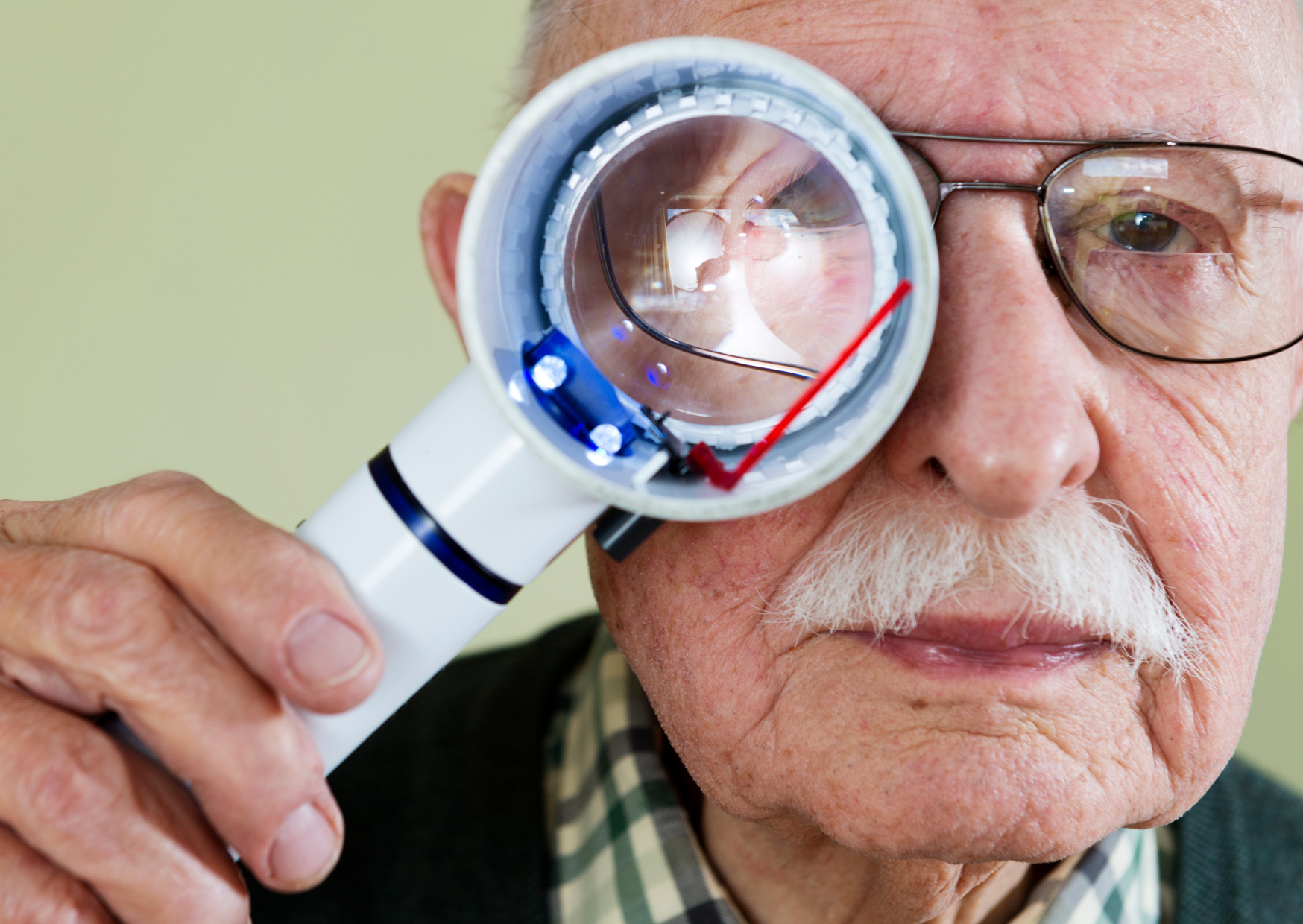 An elderly woman checking the blood pressure of her elderly husband