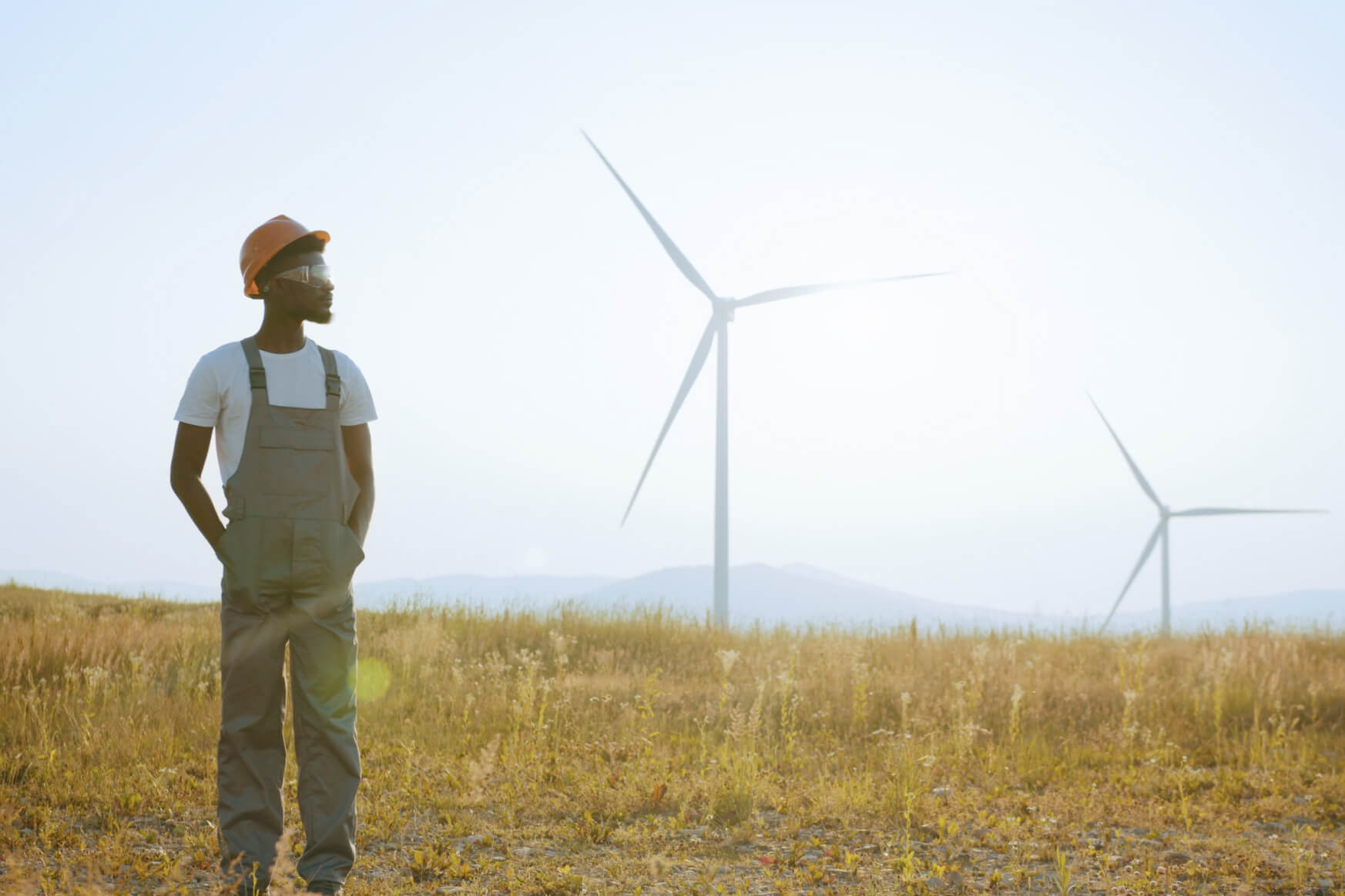 Man Standing and looking at Windgust Wind Turbines