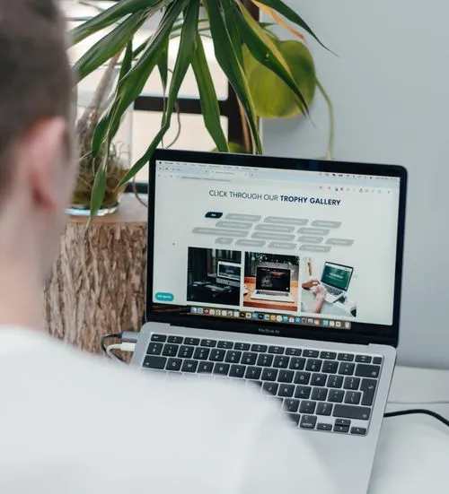 MacBook open showing Pathfind Media's website design page