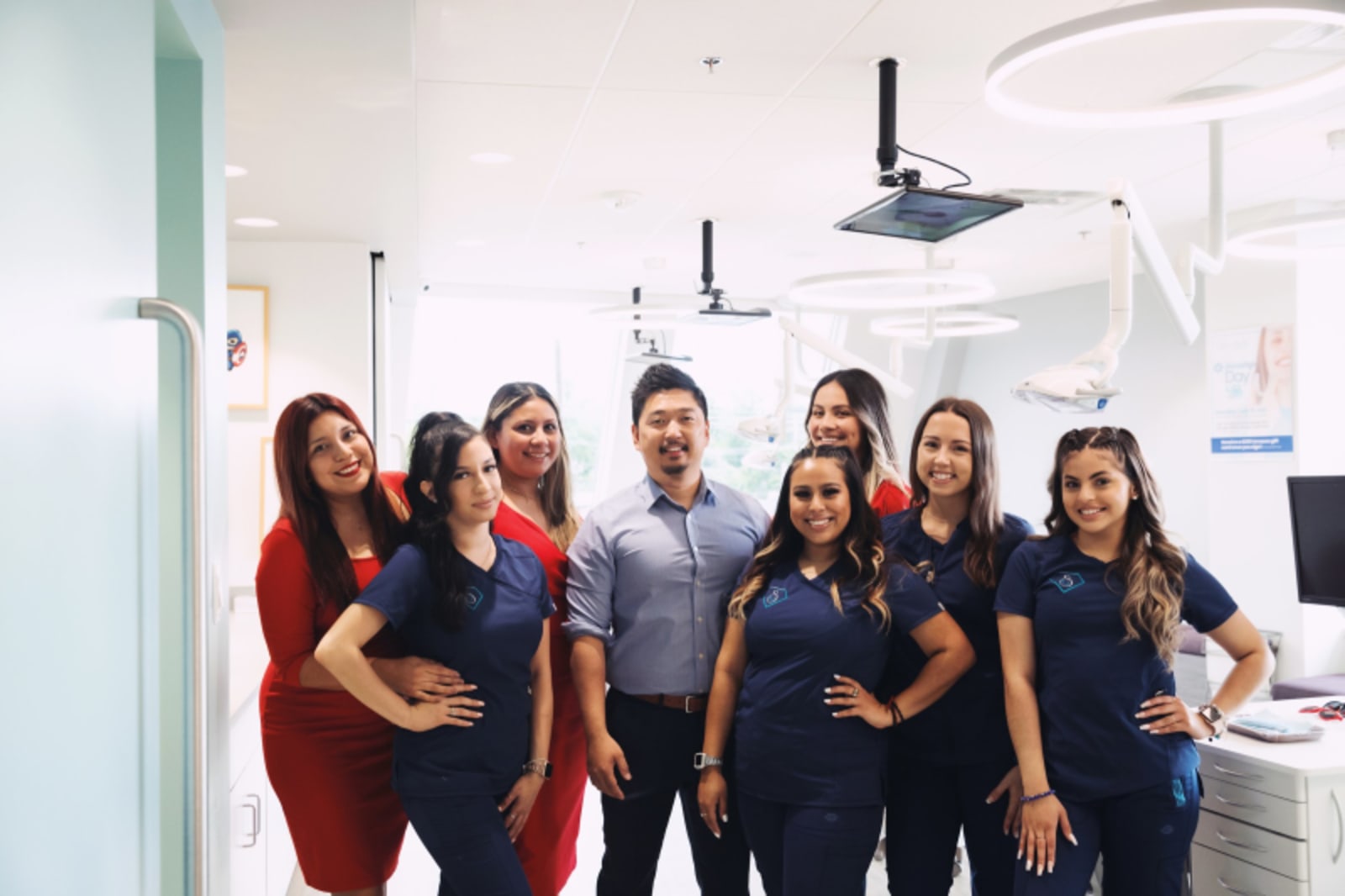 SuperKids pediatric dental team posing together in treatment room