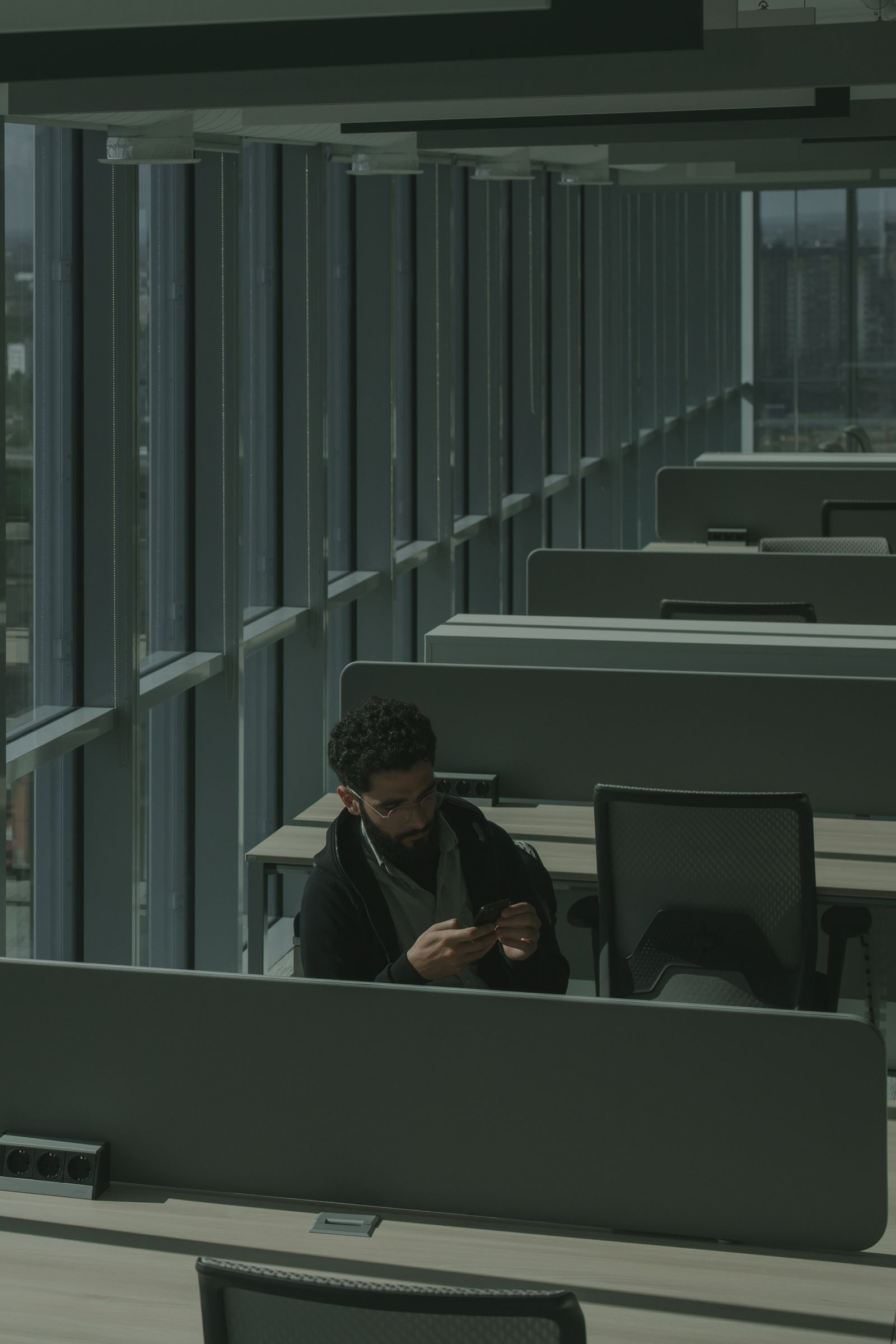 One person working alone in a large empty office