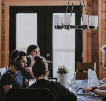 People in a boardroom sitting  at a table