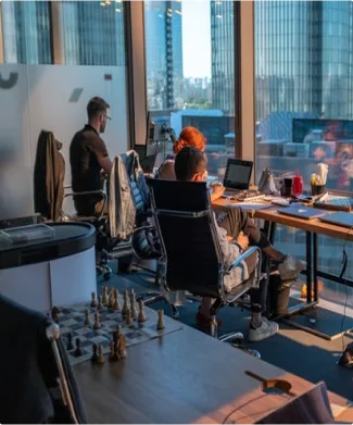 Several people in an office with view outside of city