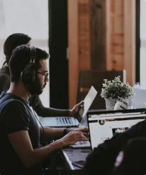 Staff with headphones building website