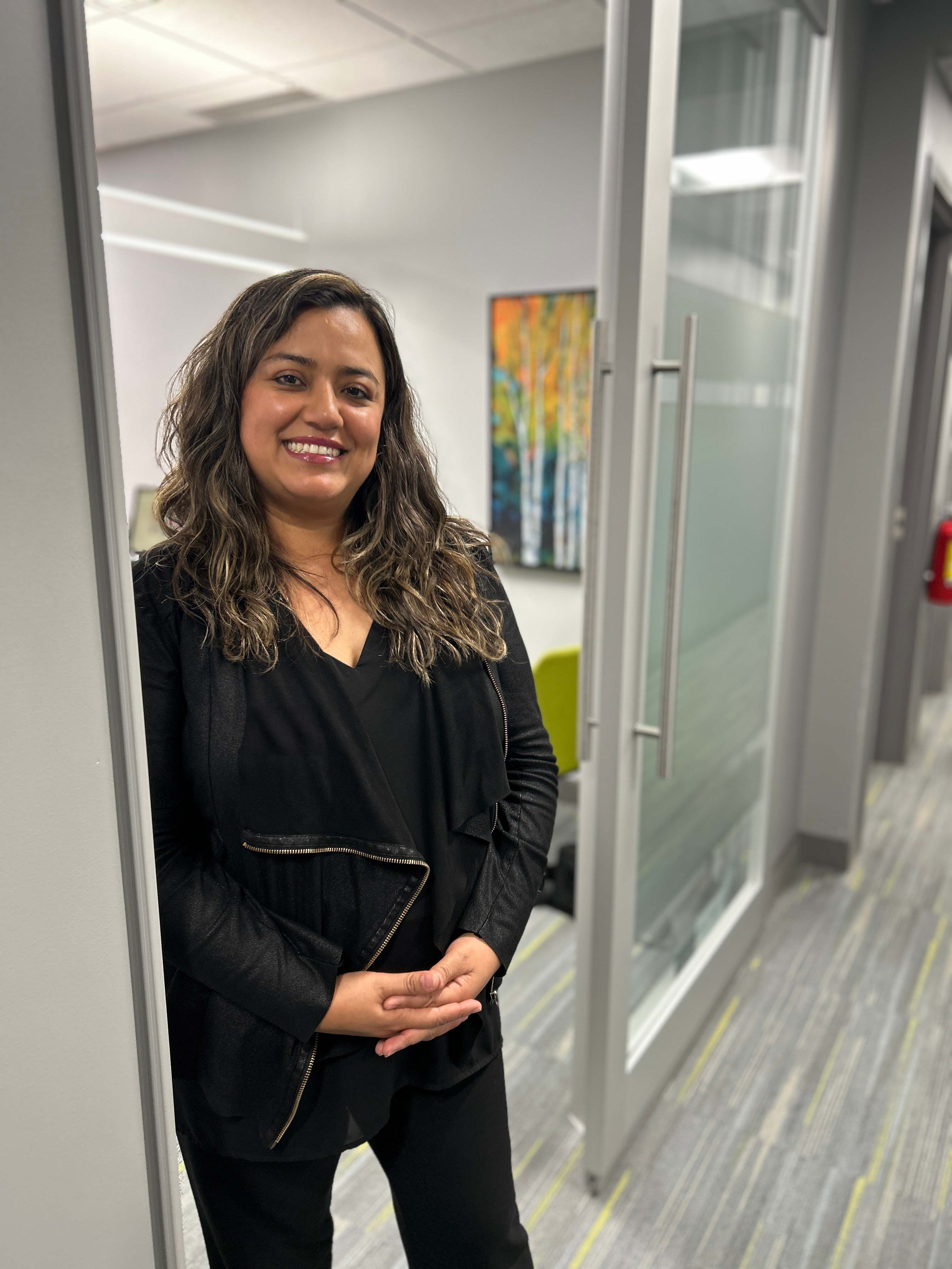 A smiling woman in a doorway