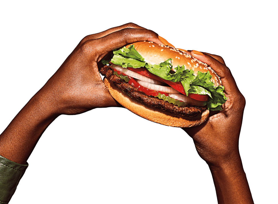 Hands holding a sandwich.