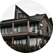 A modern house with tones of dark brown and dark grey
