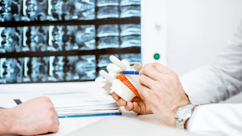 Surgeon explaining hernia recurrence risks to patient.