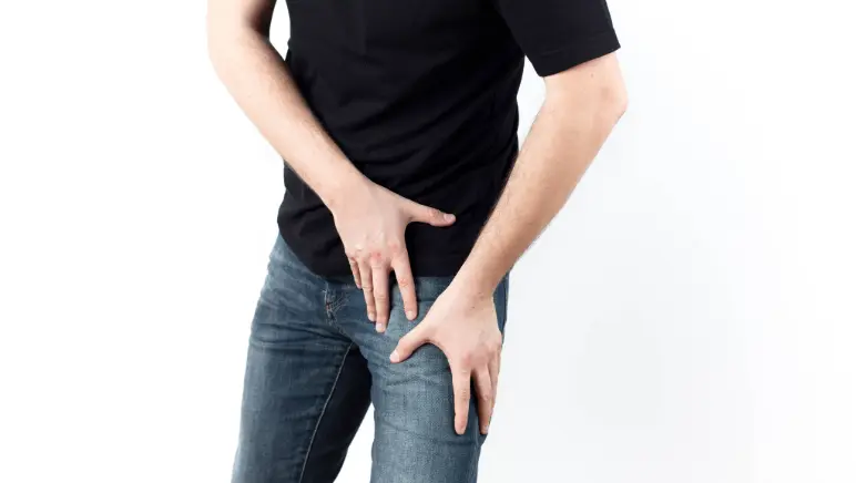 Man holding his groin area with a pained expression — symbolizing possible hernia pain.
