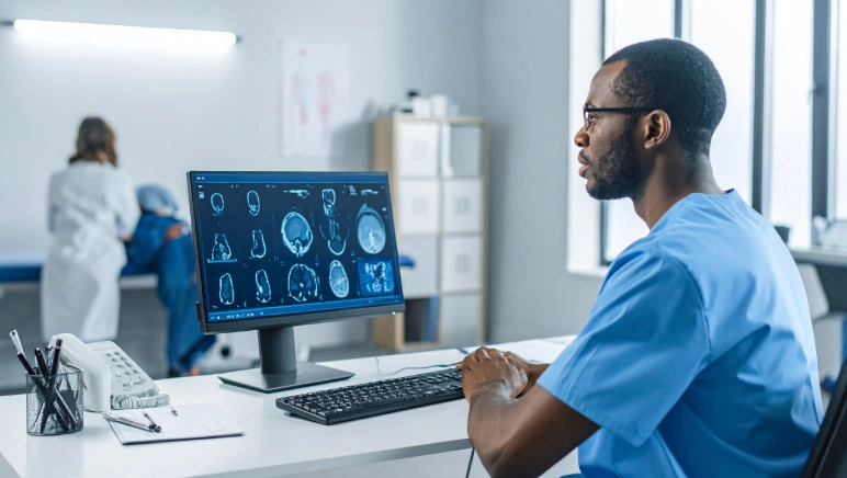 Surgeon reviewing imaging studies while discussing hiatal hernia treatment recommendations
