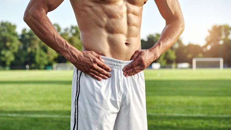 Athlete with lower abdominal and groin pain caused by a possible sports hernia, also called athletic pubalgia.