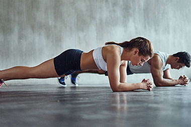 woman and a man ng plank exercise