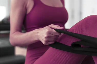 a woman working out with elastic bands