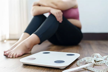 woman feeling bad after weighting her self