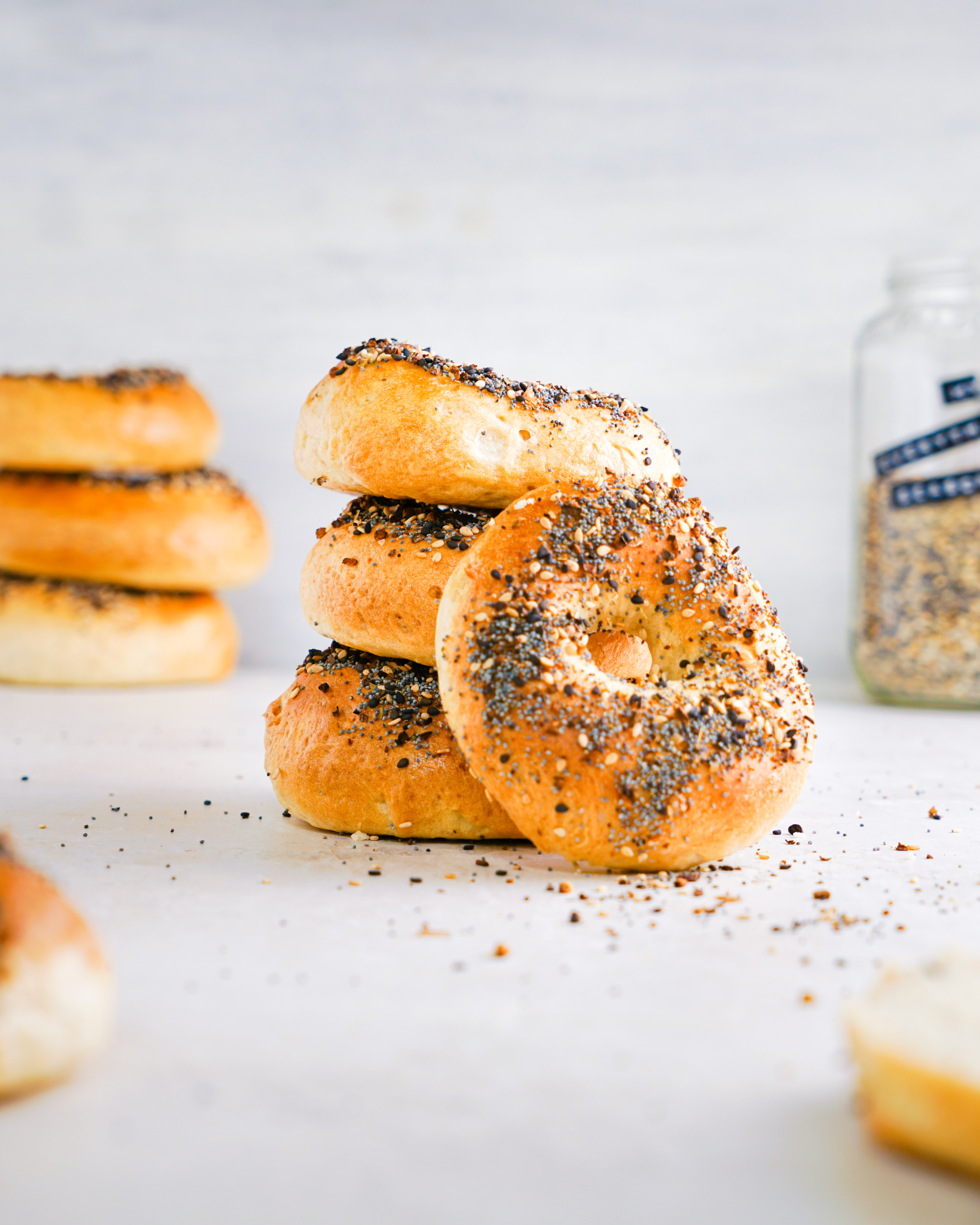 Homemade vegan bagels topped with everything bagel seasoning on a wooden board