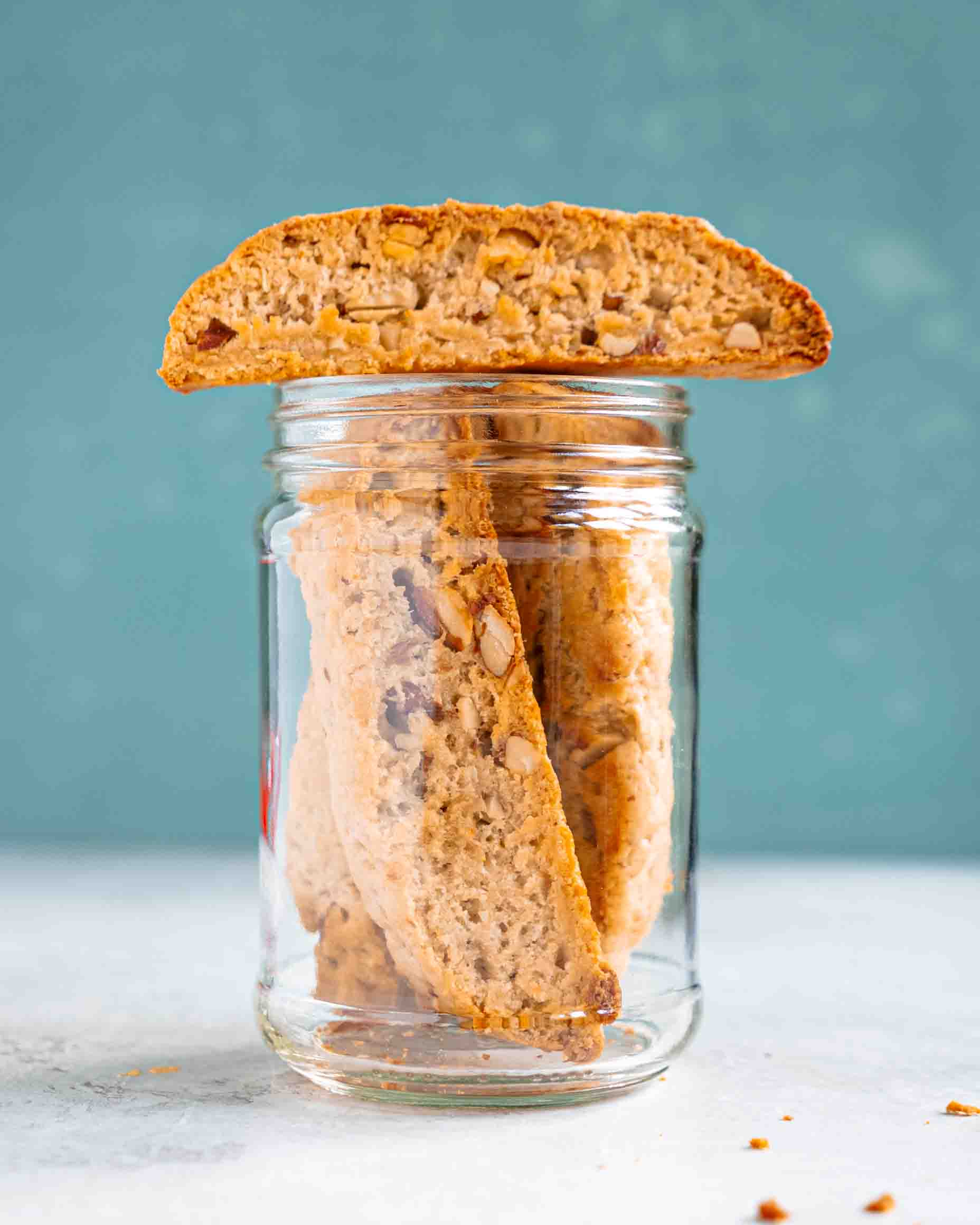 Golden vegan almond biscotti arranged on parchment paper showing crispy double-baked texture