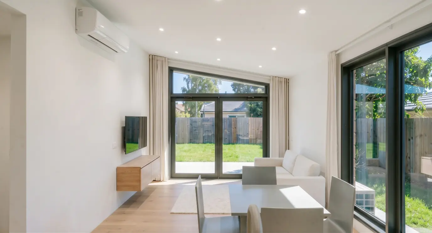 Light filled living room in the Nest Series Oak One home by Modal Architecture, with large garden facing windows and contemporary interiors.