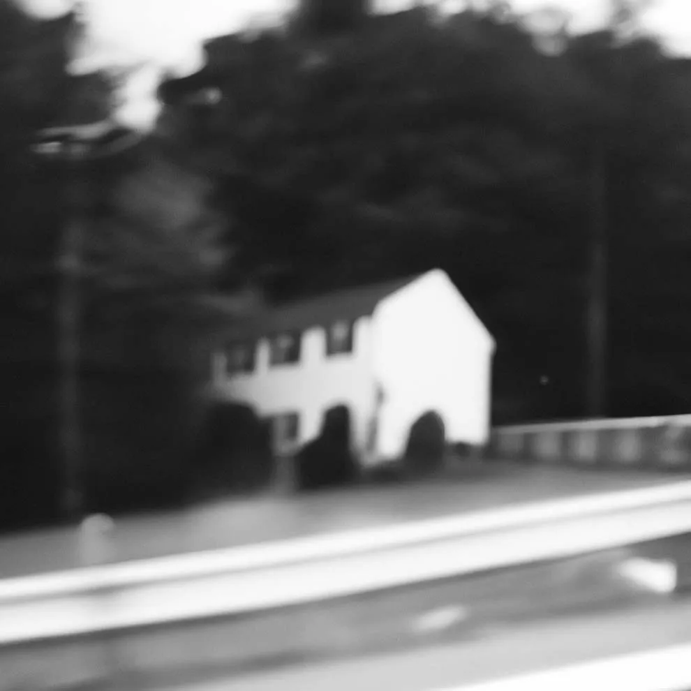 a blurry image of a house on the road