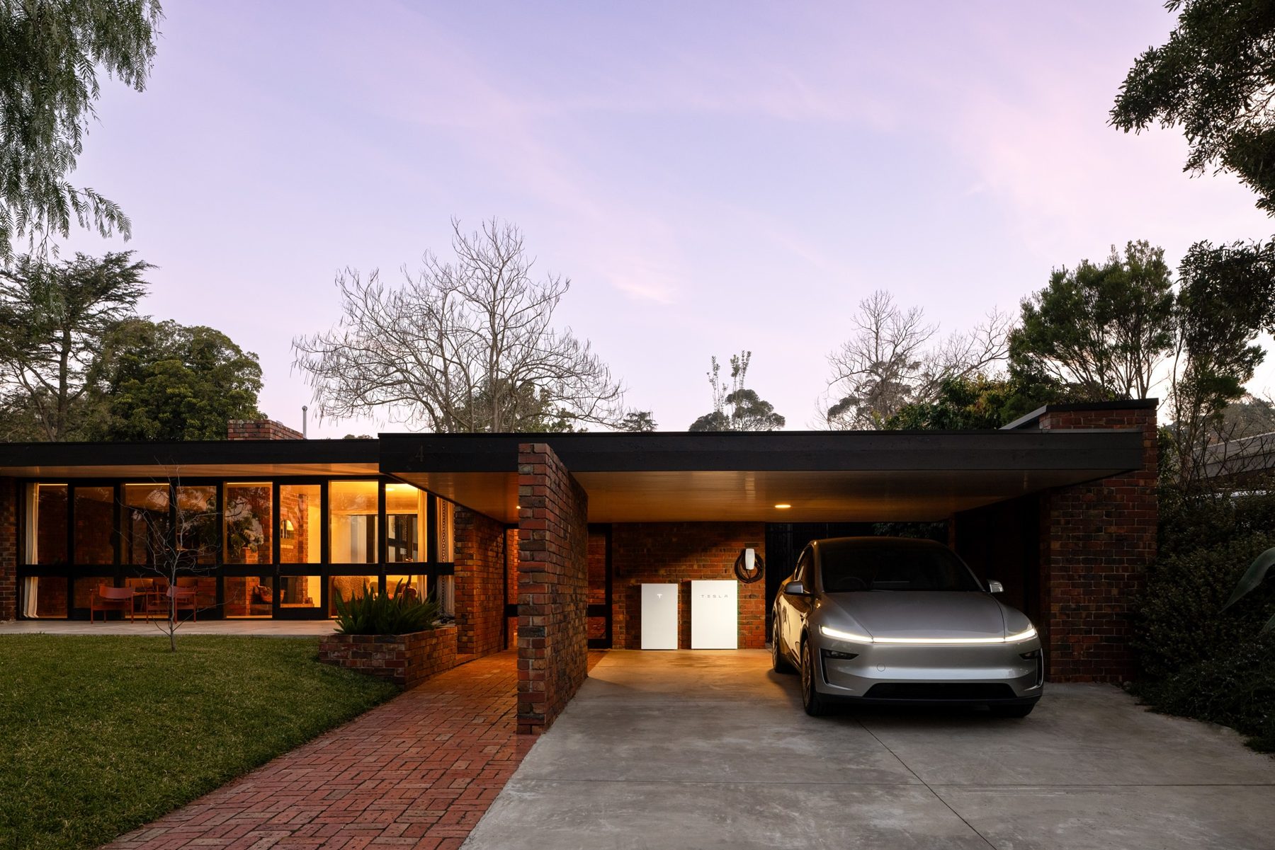 Tesla Powerwall installed on the side of a modern Australian home