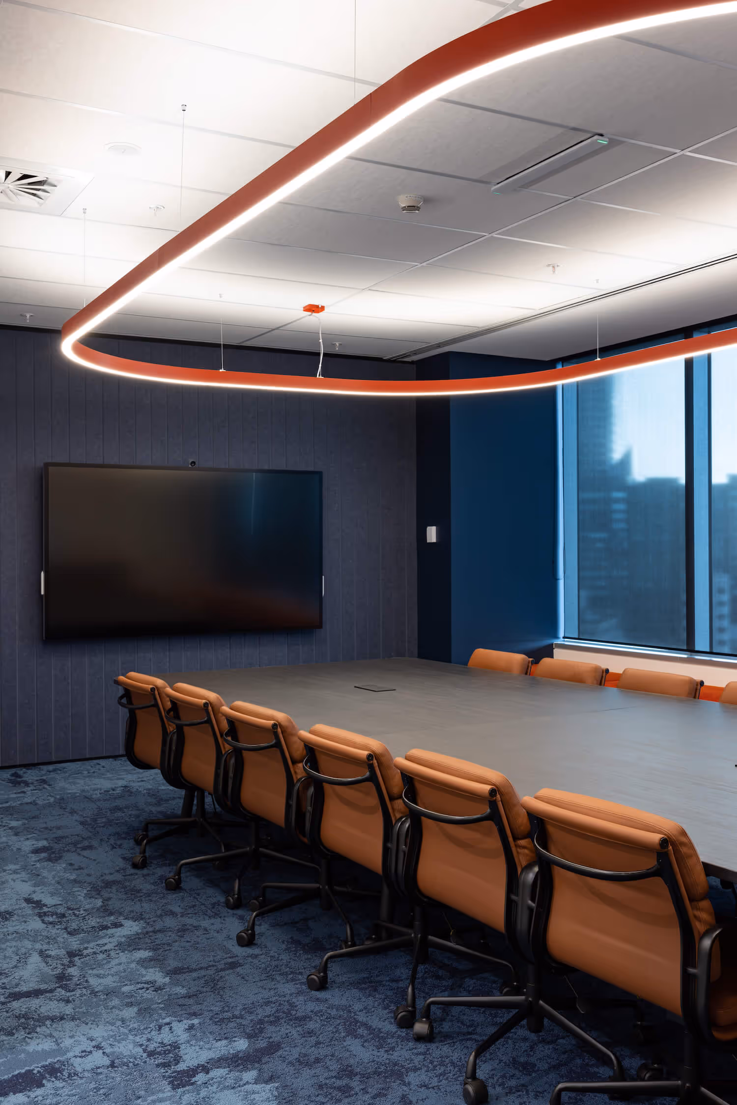 tan leather meeting chairs at large boardroom table