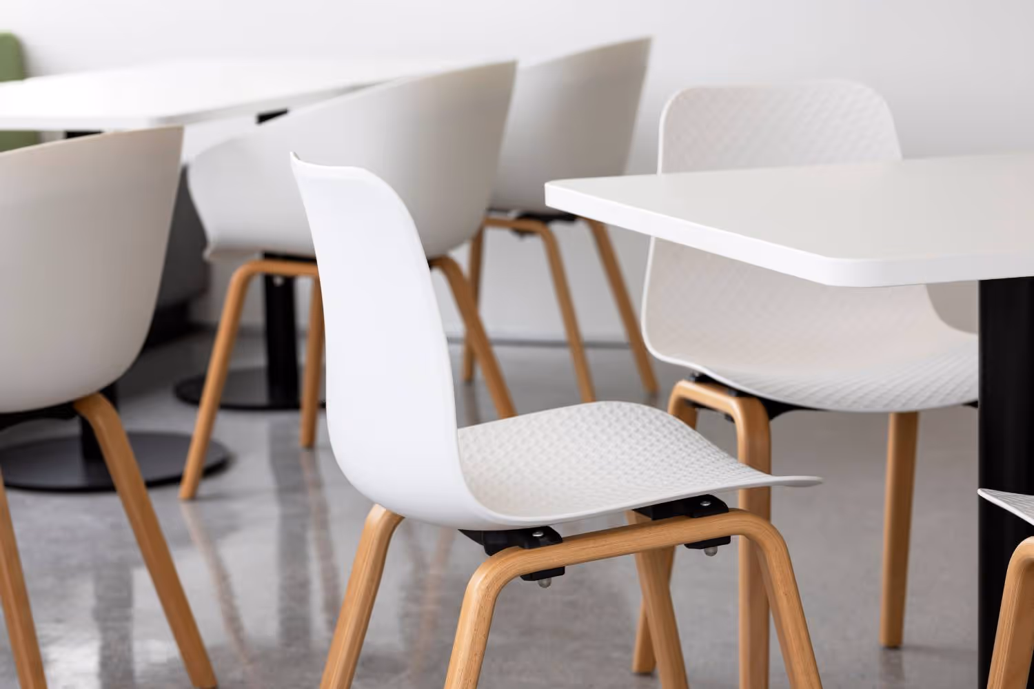 close up of white chair with wooden legs