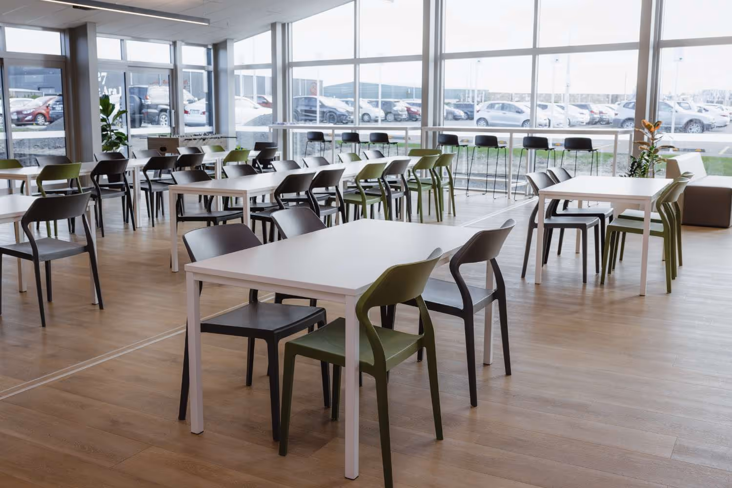 green and grey plastic cafe chairs with white tables