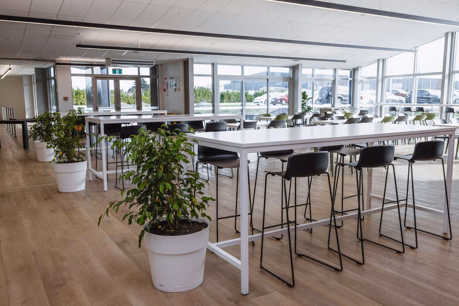 black plastic high stools and white bar leaner