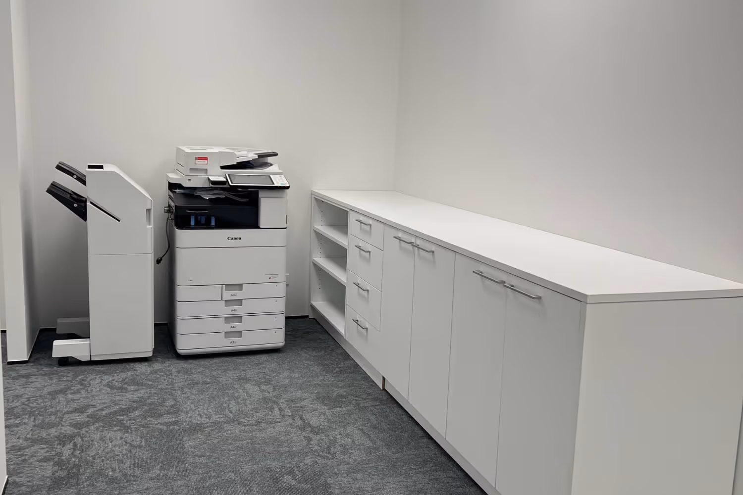 copy room and white melteca storage unit with shelving
