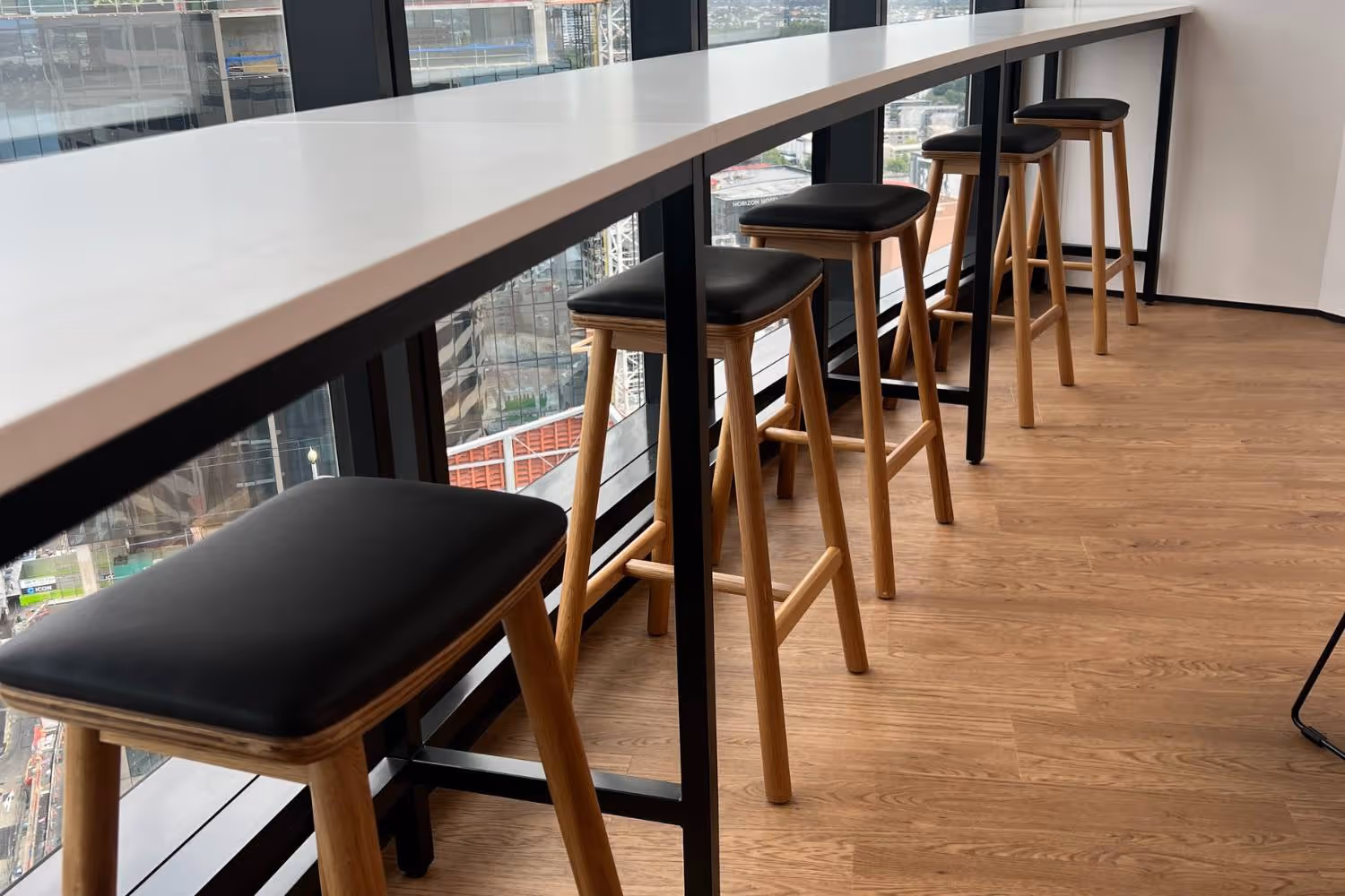 wooden stools with soft seat at bar leaner