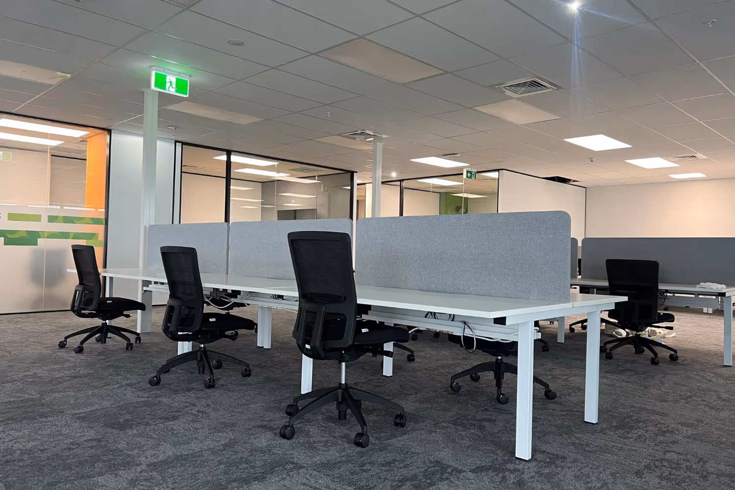 open plan office with white desks and black chairs