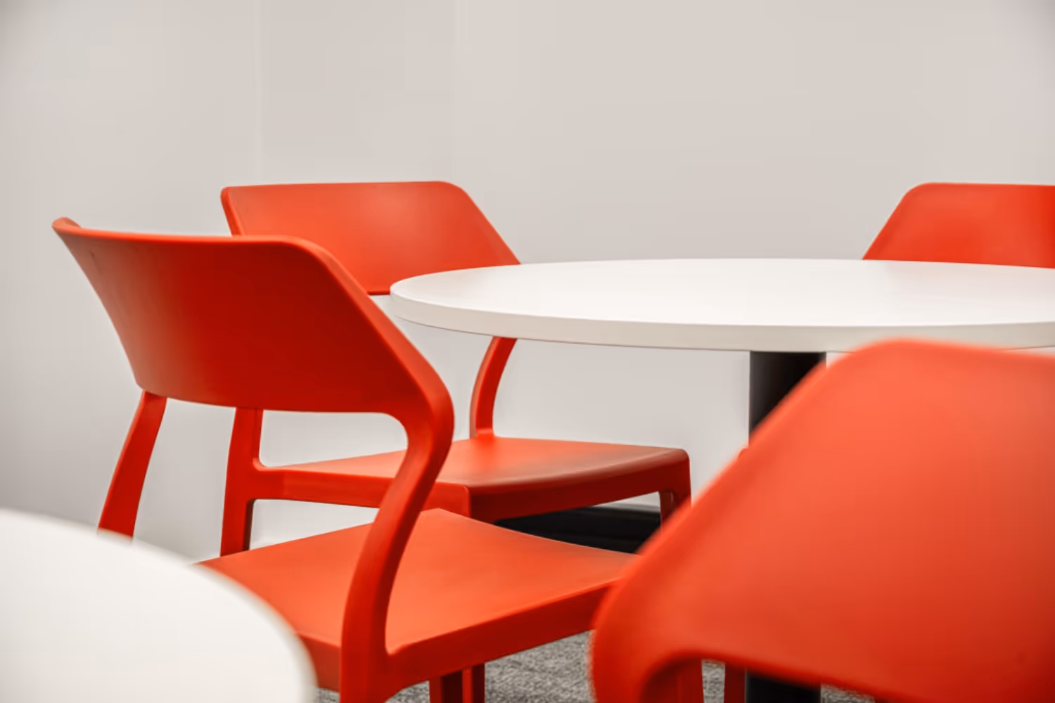 close up red plastic cafe chairs