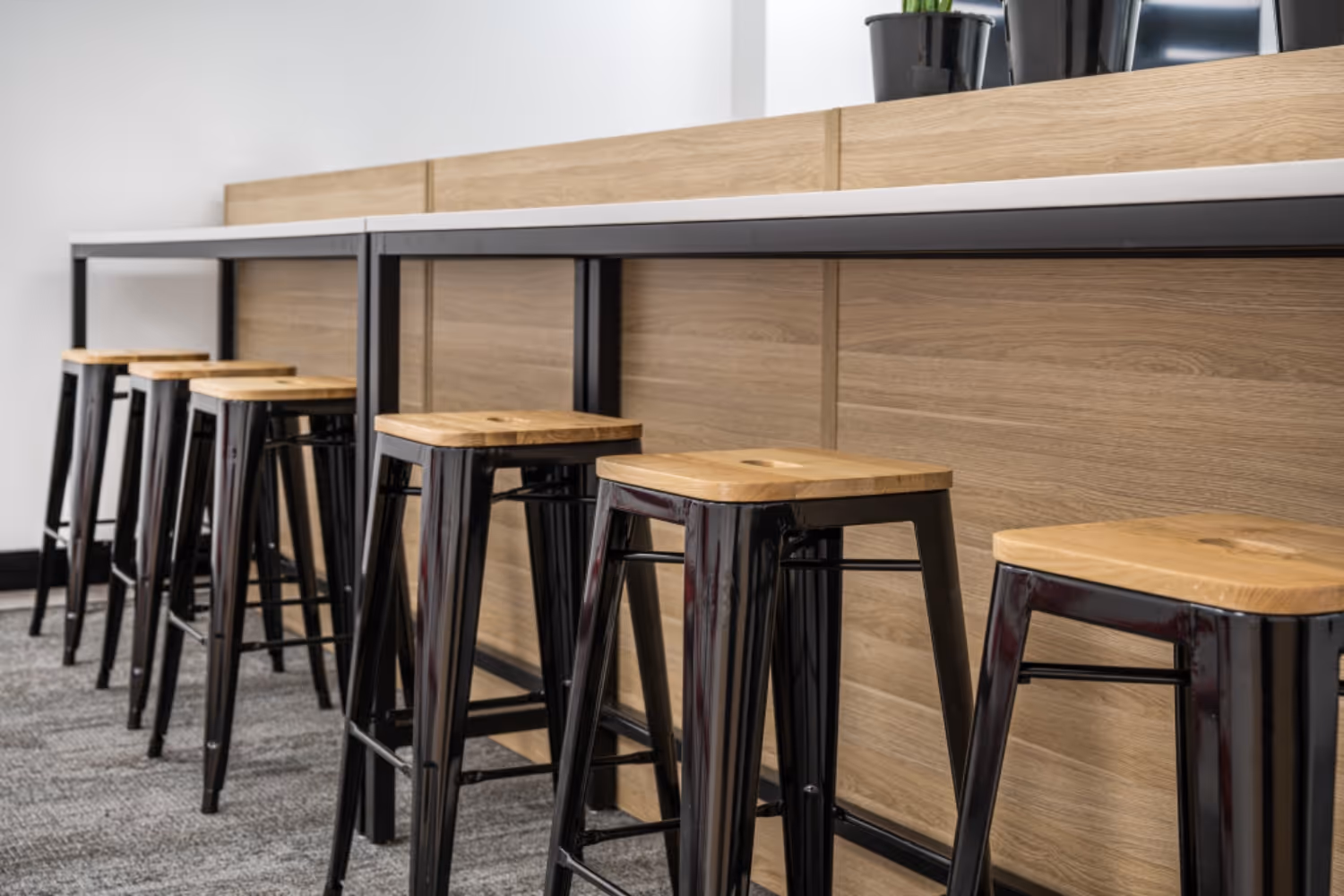 black metal high stools and bar leaner