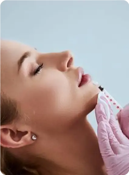 Woman receiving a lip filler injection