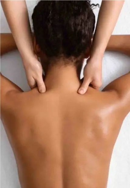 A woman giving a relaxing massage to another woman at spa