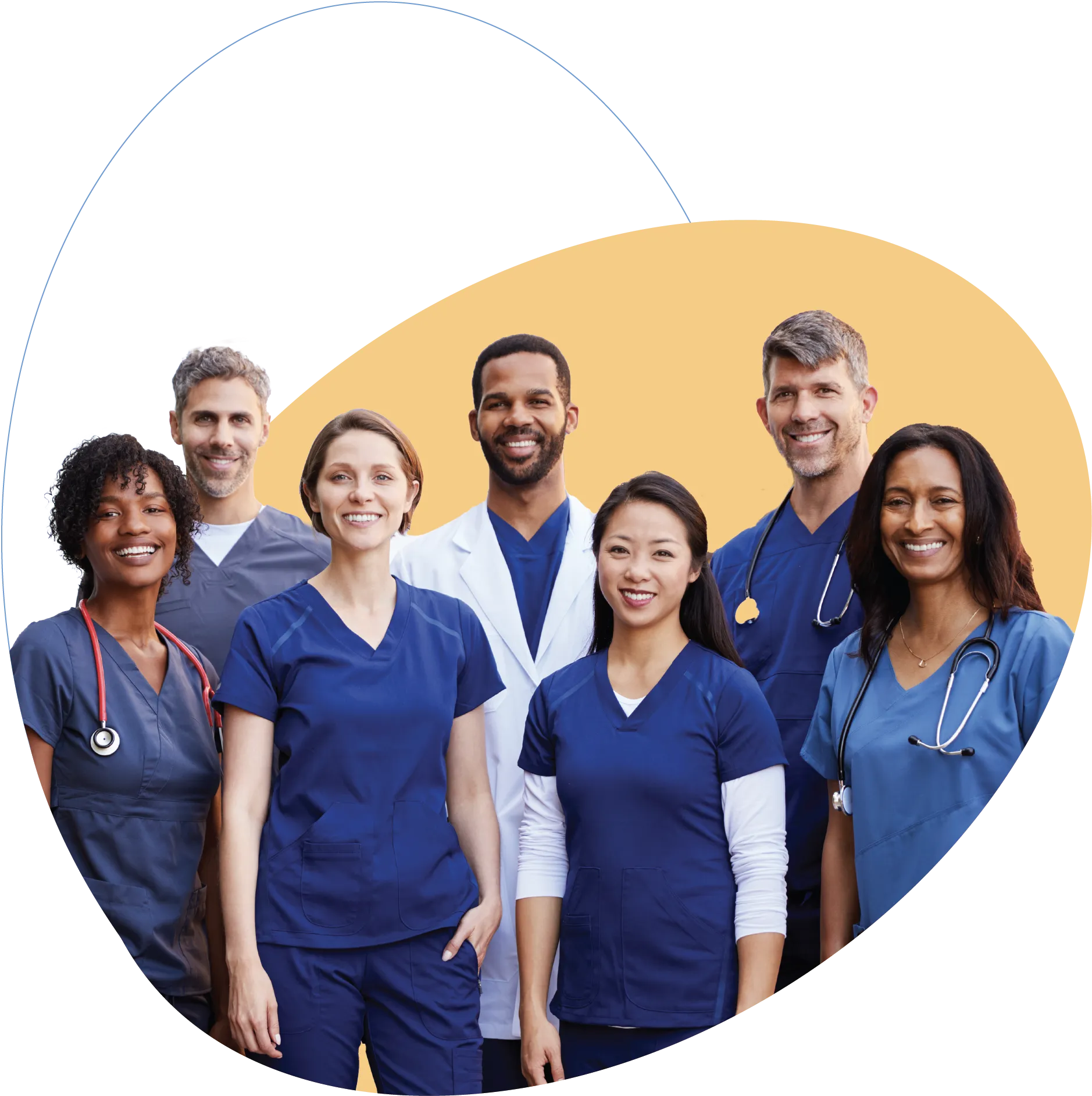 Group of seven diverse medical professionals in scrubs and lab coat smiling.