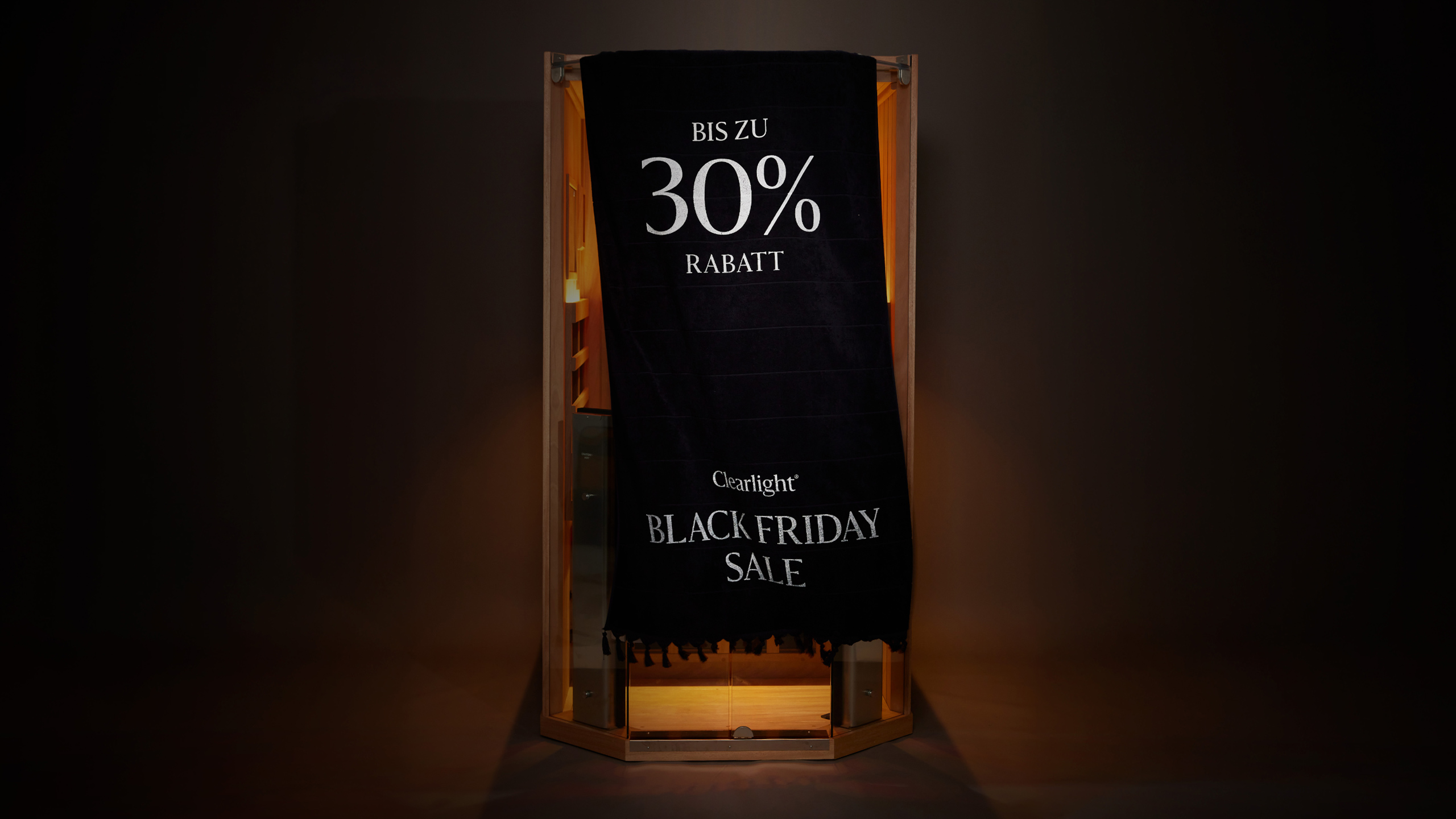 Image of Clearlight® Sanctuary Yoga sauna in large open ad light-filled room, with lake views through tall windows, and mid century lounge chair, and cat curled up sleeping on a rug.