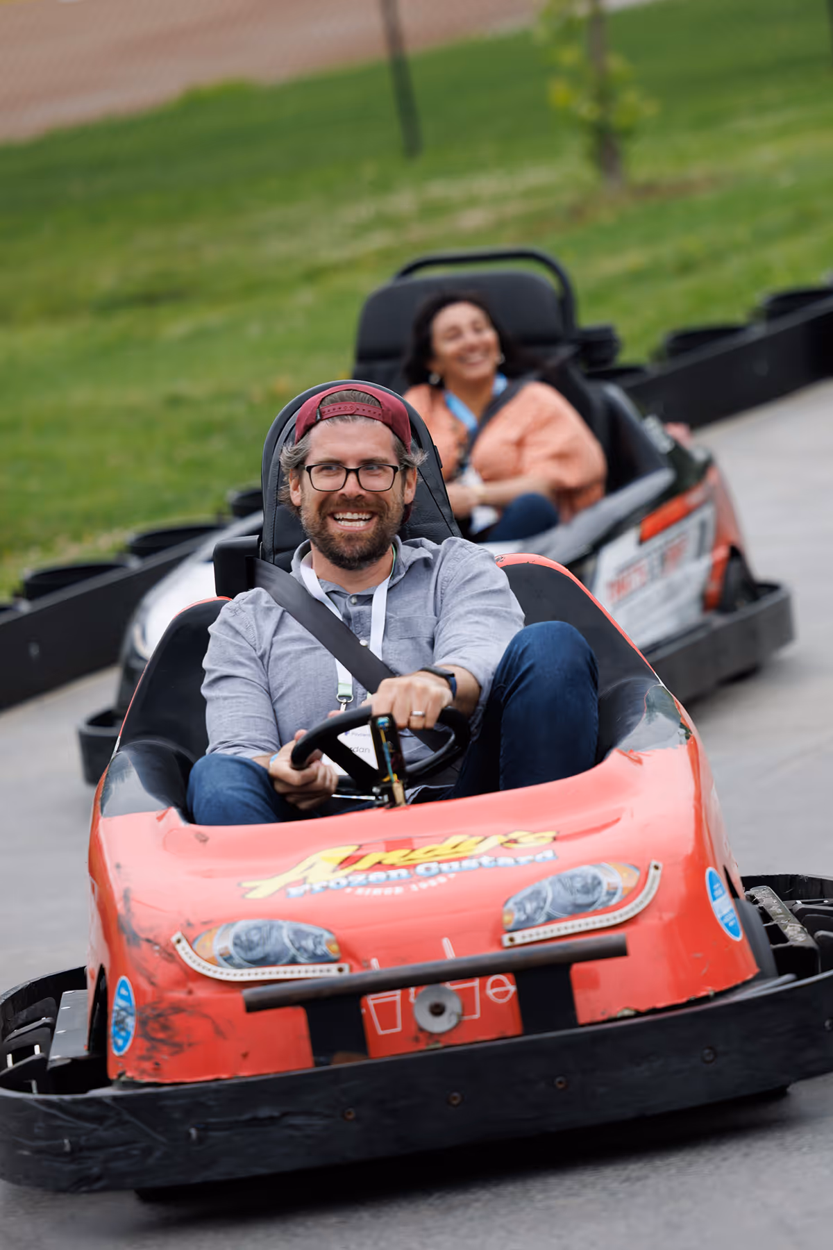 Two employees racing go-karts.