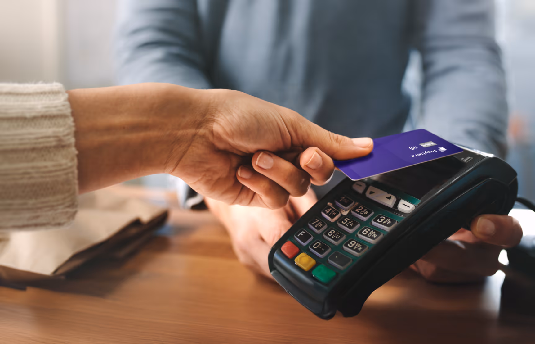 A woman using her Paytient card at a point-of-sale terminal.