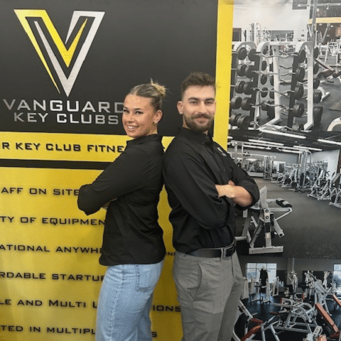 Two fitness professionals standing back-to-back in Vanguard Key Clubs gym