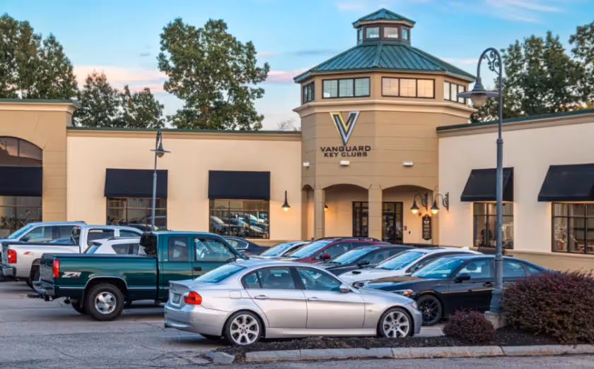 Vanguard key club exterior with parked cars in parking lot at dusk