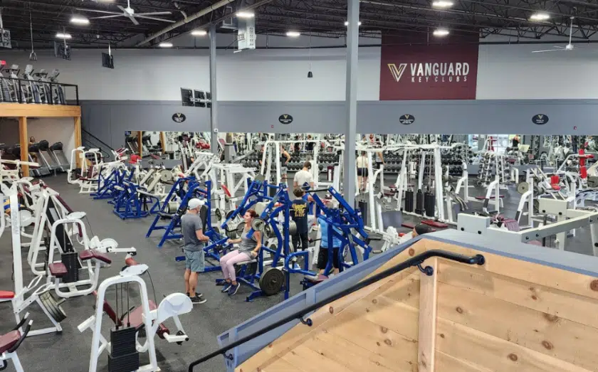 Vanguard gym interior with multiple blue and white exercise machines