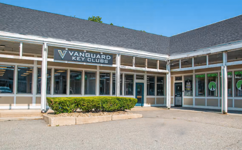 Exterior view of a Vanguard Key Clubs fitness center with branded signage and storefront windows.