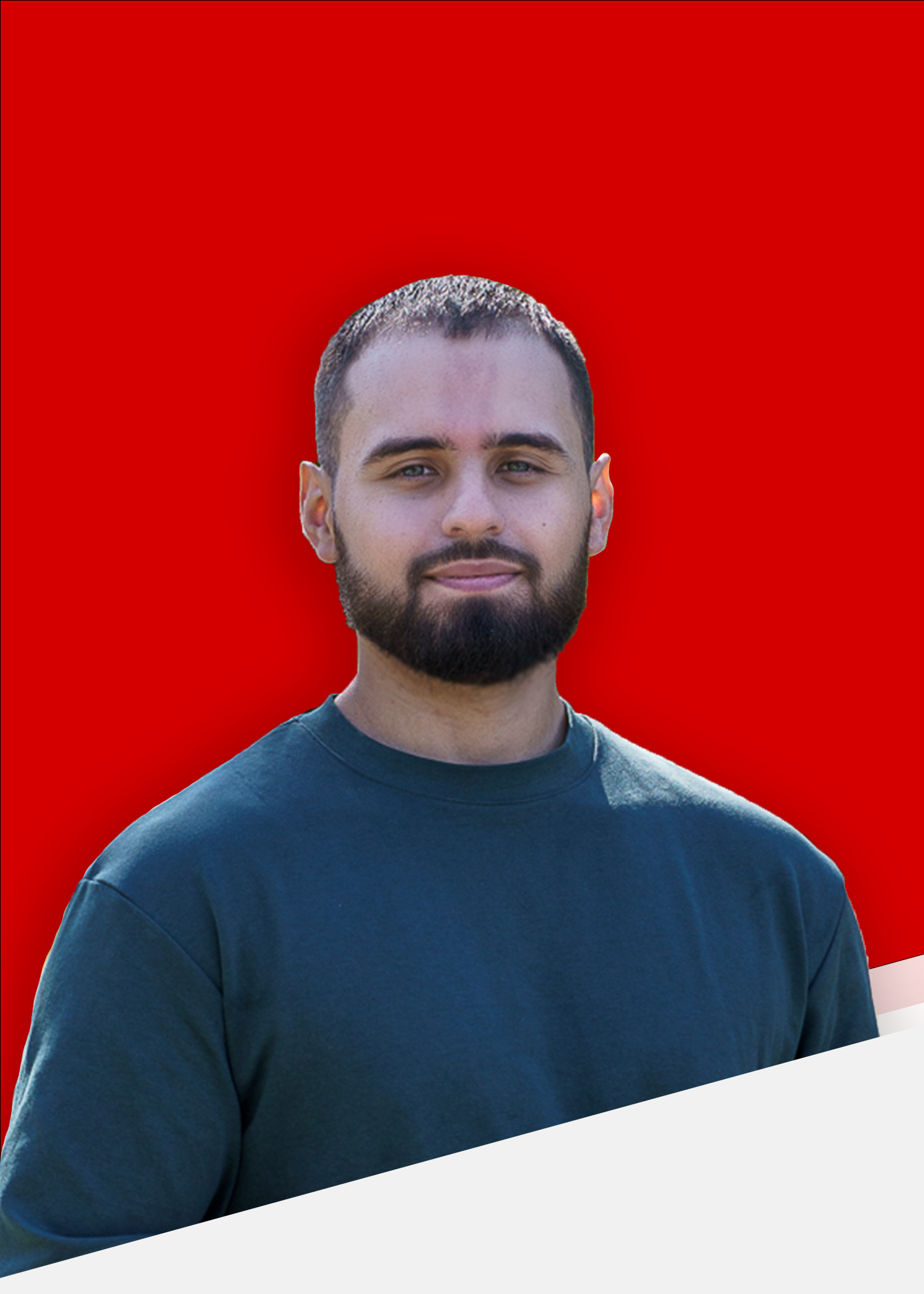 A portrait of a Cristian Pineda, a man with a beard and short hair, light eyes, he is smiling and looking directly at the camera. He is wearing a dark green crew neck t-shirt. The background is a vibrant red, creating a strong contrast with the subject. The man's demeanor is friendly and approachable.
