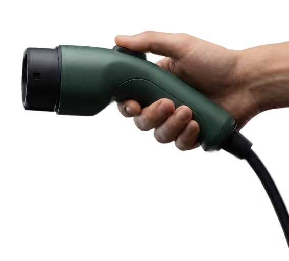 Hand holding a green electric vehicle charging connector with a black cable.