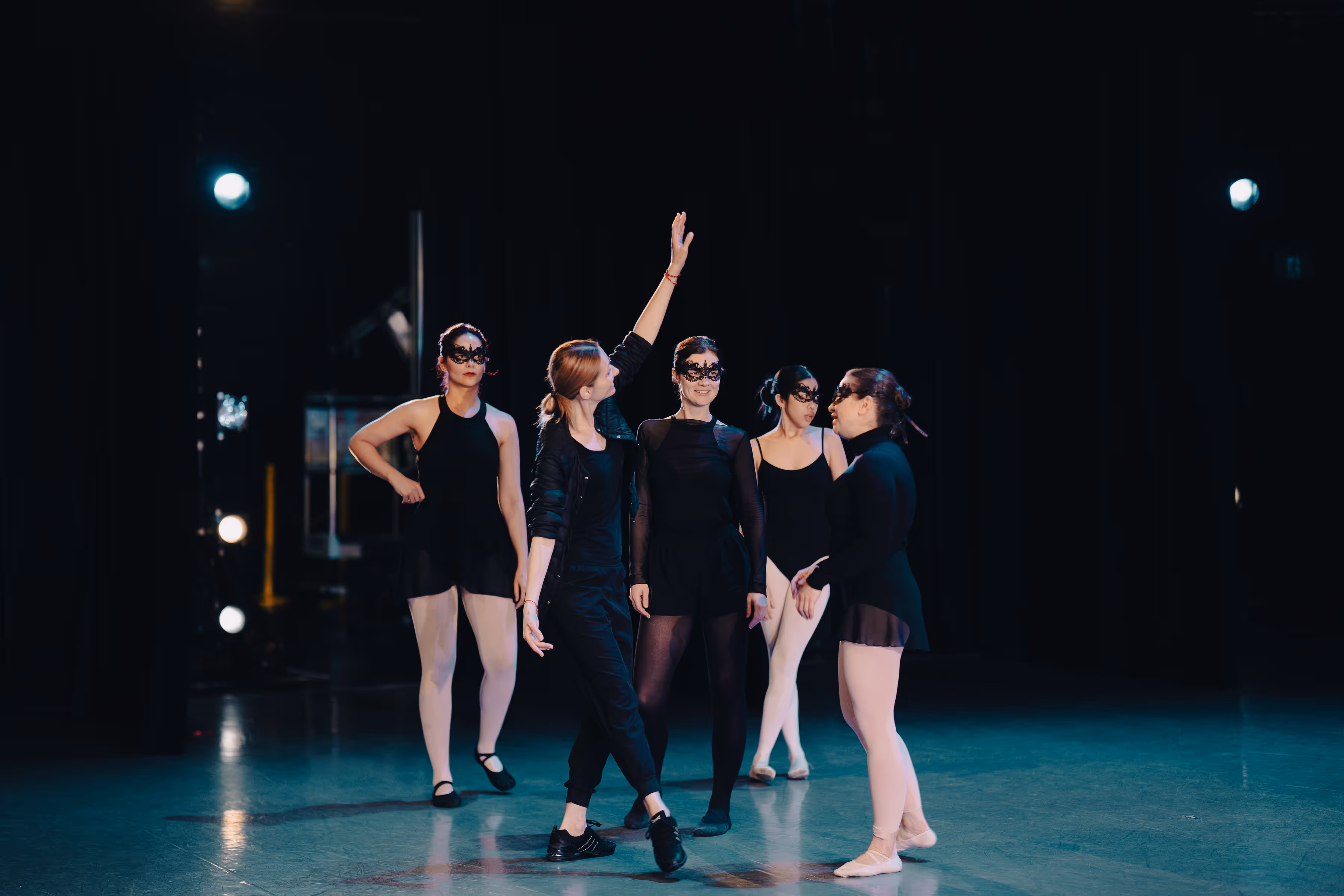 Adult amateur dancers gathered with their teacher backstage on the stage just before The Russian Ballet School performance at Betty Oliphant Theatre in Toronto