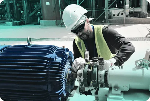 Man in hard hat fixing machine