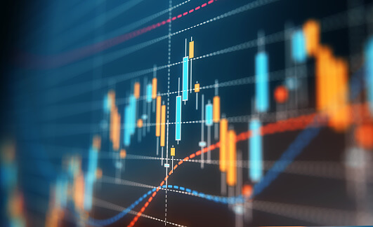 Close-up of a candlestick trading chart with blue and orange bars