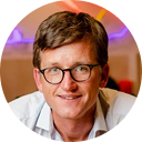 Smiling man with glasses in a light shirt