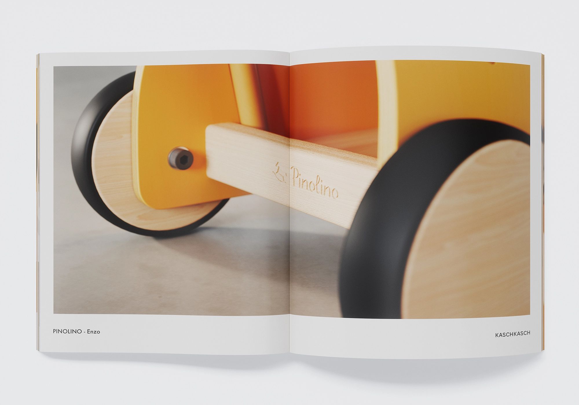 Macro detail on the Enzo: wheel and axle with Pinolino logo; materiality of wood and plastic realistically depicted - CGI product image.
