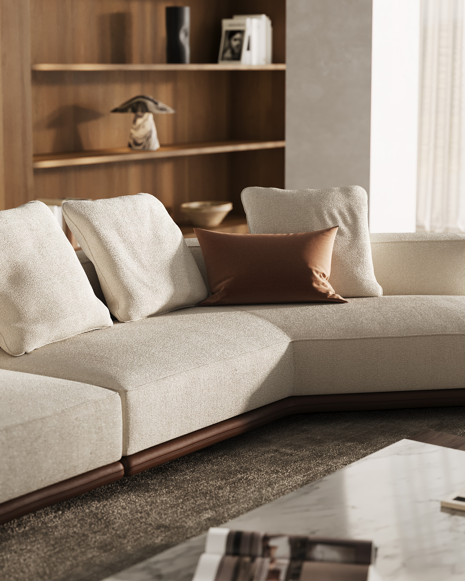 A light-colored sofa in side lighting, with back cushions and a dark wooden base